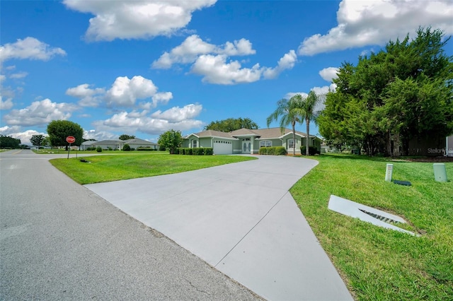 view of front of home with a garage and a front lawn