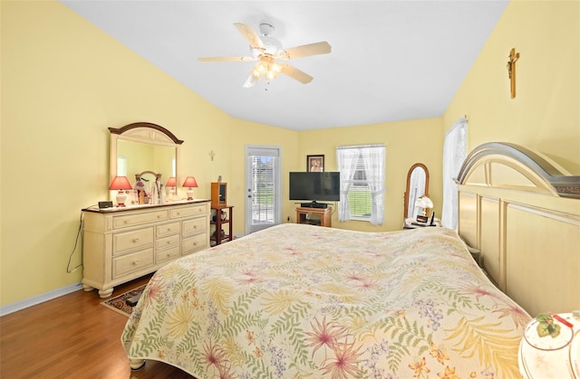 bedroom with lofted ceiling, access to exterior, ceiling fan, and hardwood / wood-style floors