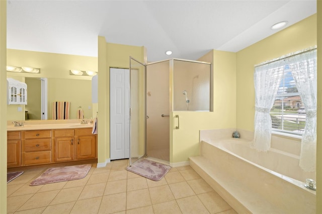 bathroom featuring vanity, plus walk in shower, and tile patterned floors