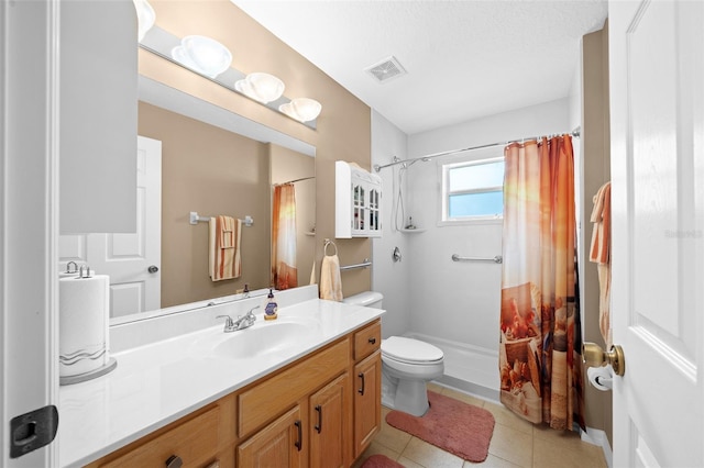 bathroom with tile patterned floors, a shower with curtain, toilet, and vanity