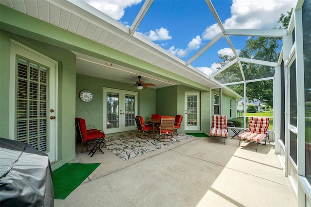 view of patio / terrace featuring ceiling fan, glass enclosure, and french doors