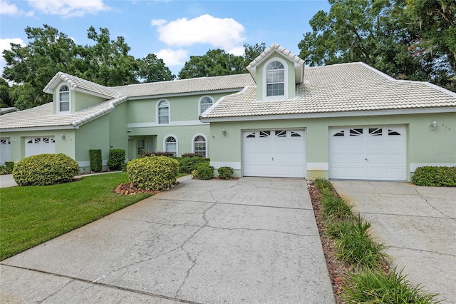 view of front property featuring a garage and a front lawn