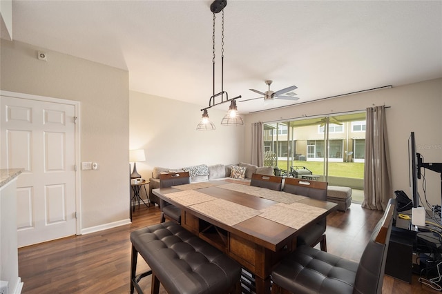 dining room with ceiling fan and dark hardwood / wood-style floors