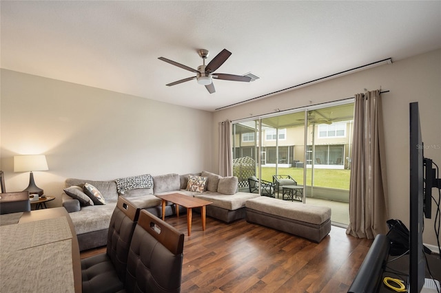 living room with ceiling fan and dark hardwood / wood-style flooring