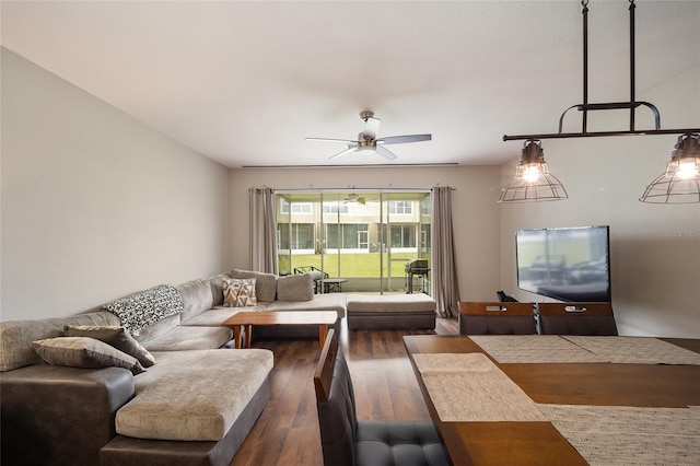 living room with dark wood-type flooring and ceiling fan