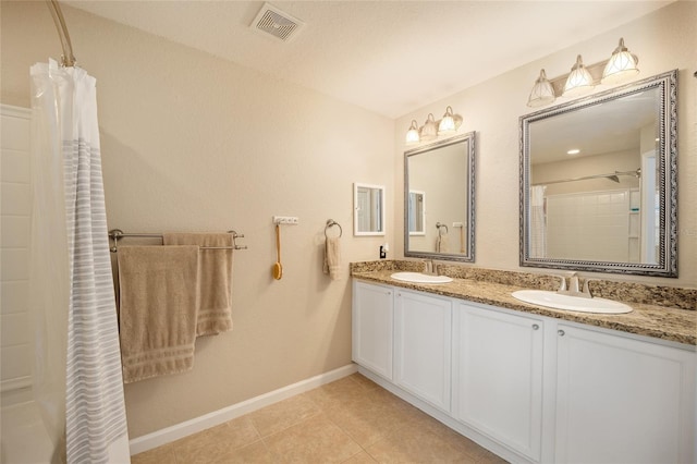 bathroom featuring tile patterned flooring, vanity, curtained shower, and a textured ceiling