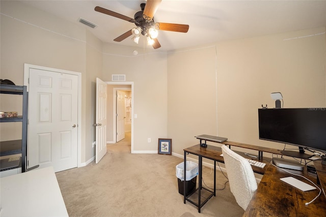 carpeted office space with ceiling fan