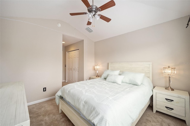 carpeted bedroom with lofted ceiling, ceiling fan, and a closet