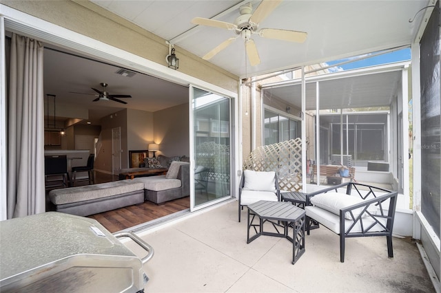 sunroom featuring ceiling fan