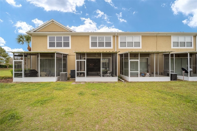 back of property featuring a sunroom and a yard