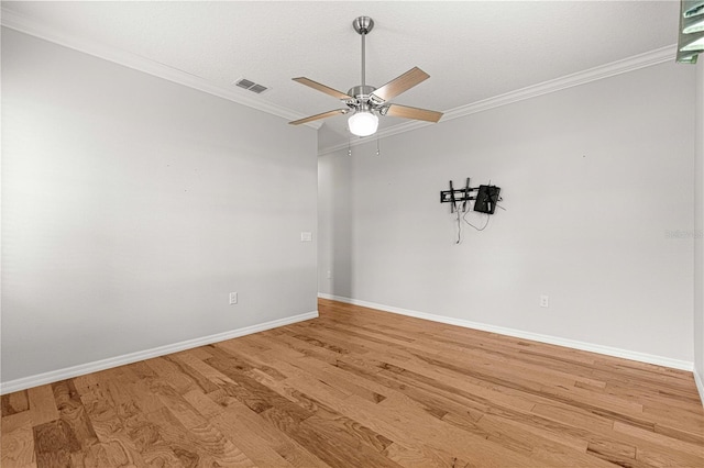 unfurnished room with a ceiling fan, light wood-type flooring, visible vents, and crown molding