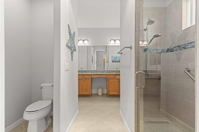 bathroom featuring toilet, vanity, a textured ceiling, and walk in shower