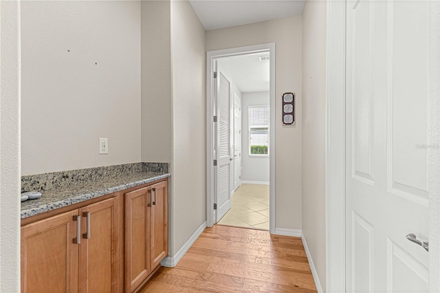 hallway with light hardwood / wood-style flooring