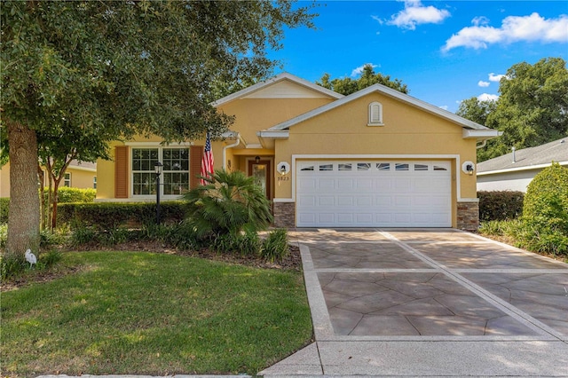 view of front of house featuring an attached garage, a front lawn, concrete driveway, and stucco siding