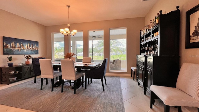 tiled dining space featuring bar area and a notable chandelier