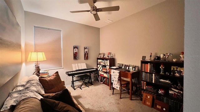 carpeted office with lofted ceiling and ceiling fan