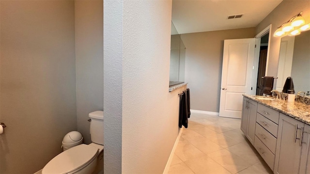 bathroom featuring tile patterned floors, toilet, and vanity