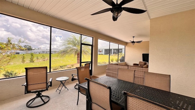 sunroom featuring wood ceiling and ceiling fan