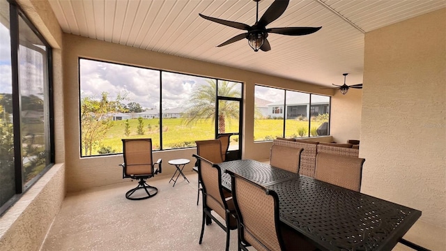 sunroom featuring wood ceiling and ceiling fan