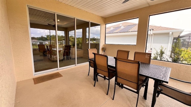 sunroom / solarium with wood ceiling and ceiling fan