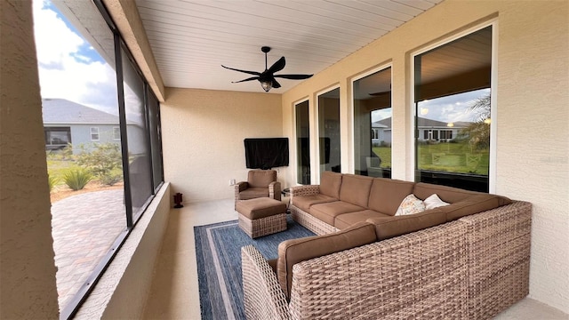 sunroom featuring ceiling fan and wood ceiling