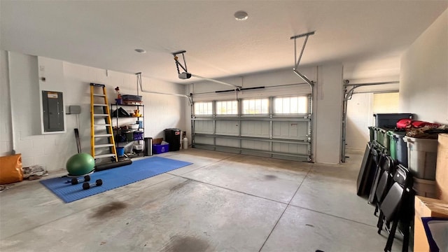 garage featuring electric panel and a garage door opener