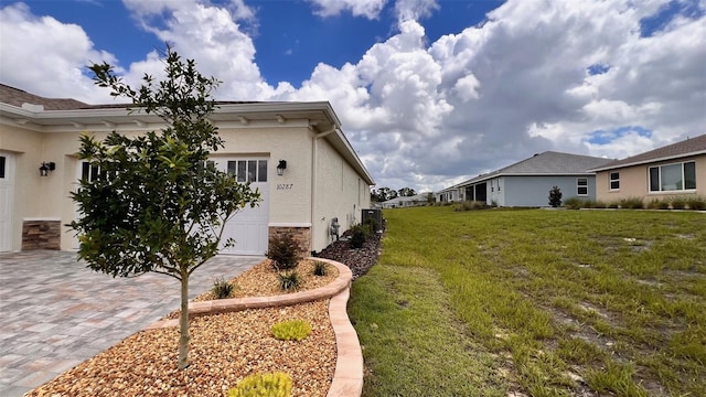 view of property exterior featuring a garage and a yard