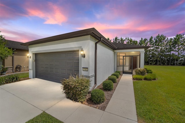 single story home with a yard and a garage