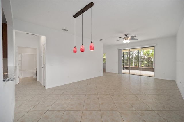 spare room featuring ceiling fan and light tile patterned floors