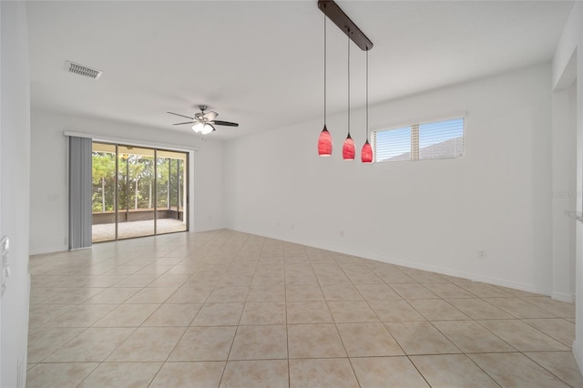 tiled spare room with ceiling fan