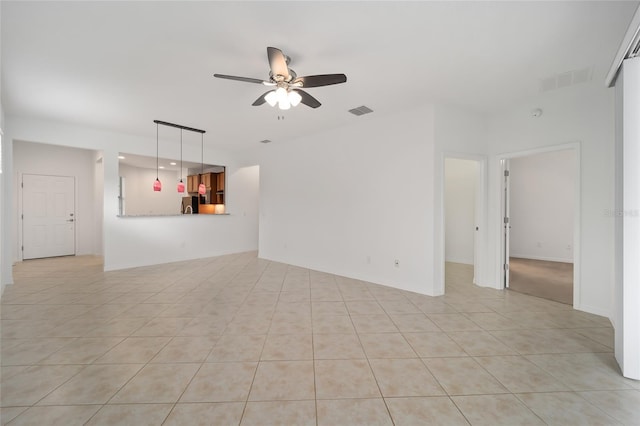 unfurnished living room featuring ceiling fan and light tile patterned flooring