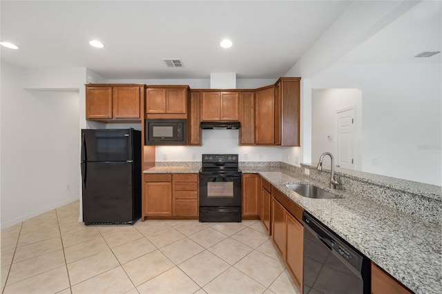 kitchen featuring black appliances, sink, light tile patterned floors, and light stone countertops