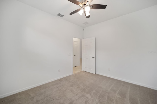 spare room featuring ceiling fan and light colored carpet