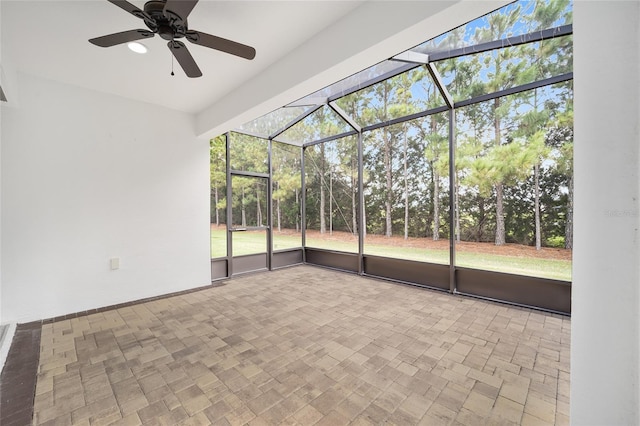 empty room with ceiling fan and plenty of natural light