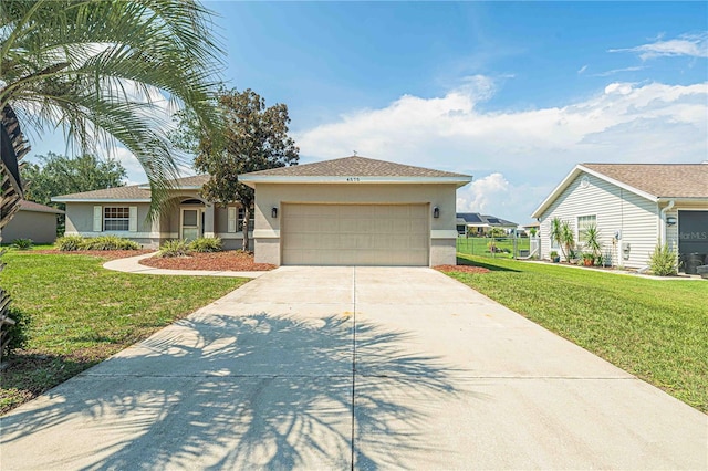 ranch-style house featuring a front yard and a garage