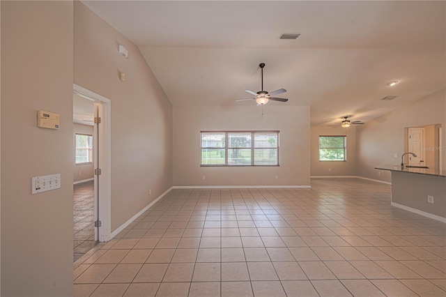 interior space with ceiling fan, sink, and vaulted ceiling