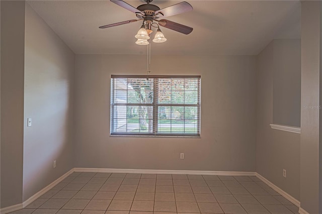 unfurnished room with ceiling fan and light tile patterned floors