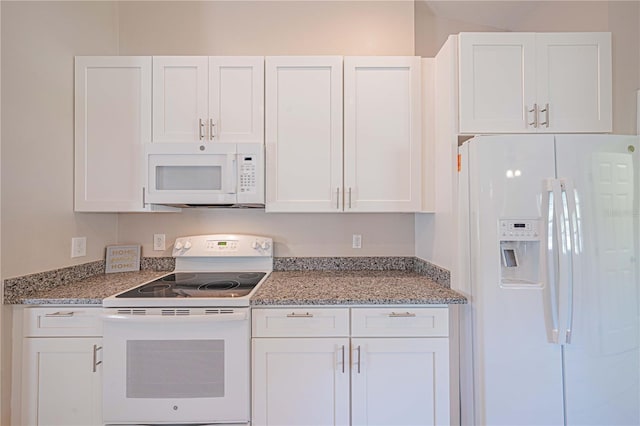 kitchen with light stone counters, white appliances, and white cabinets