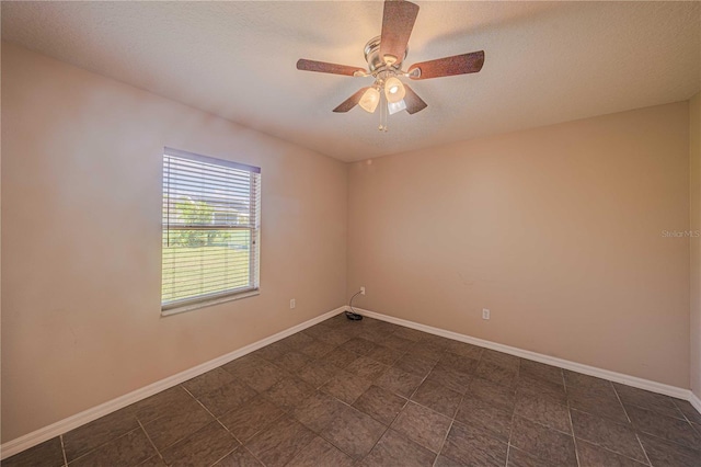 unfurnished room featuring ceiling fan and a textured ceiling