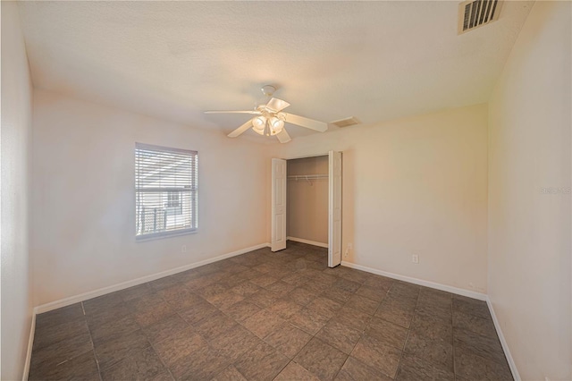 unfurnished bedroom with a ceiling fan, a closet, visible vents, and baseboards