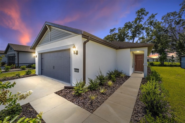 view of front of property featuring a garage and a yard