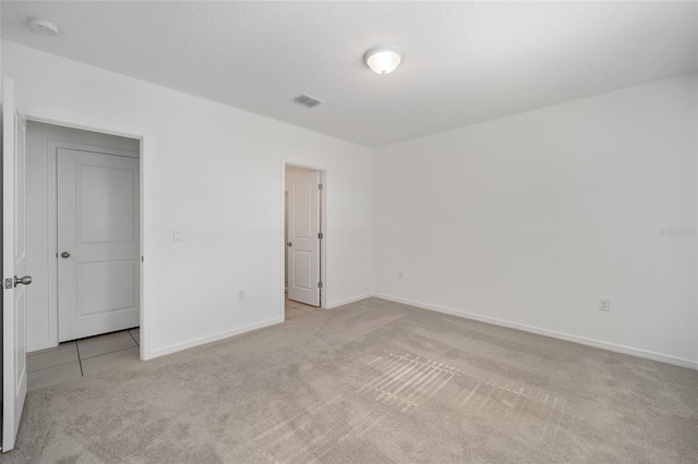 unfurnished bedroom with light carpet