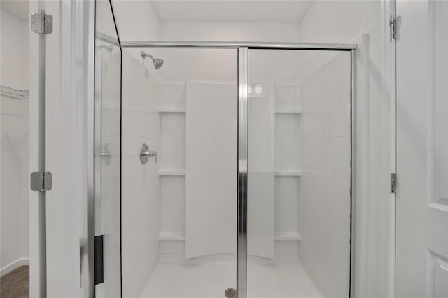 bathroom with a shower with shower door