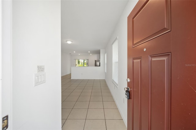 hall with light tile patterned floors