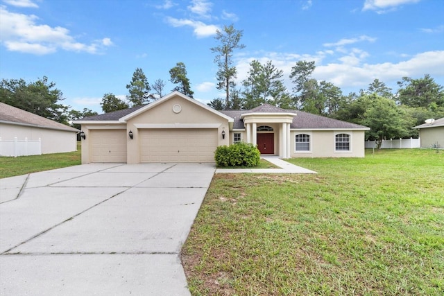 view of front of property with stucco siding, concrete driveway, an attached garage, fence, and a front lawn