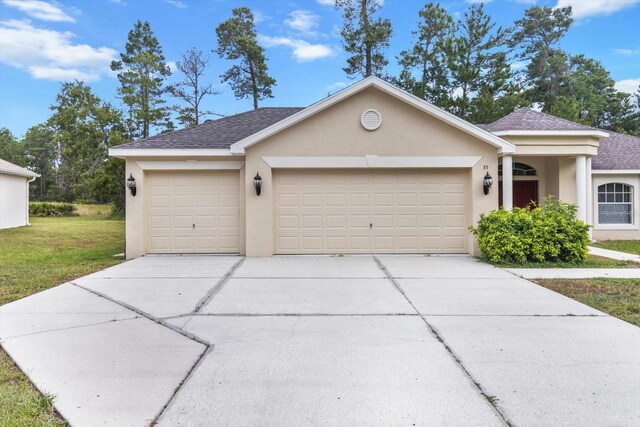 view of front of property with a garage and a front yard