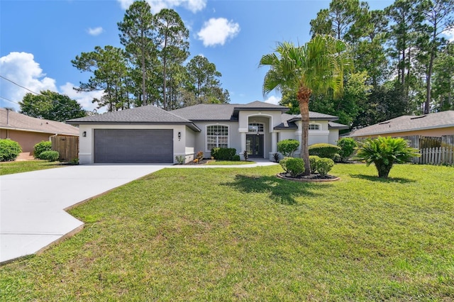 view of front of home with a garage and a front lawn