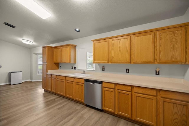 kitchen featuring dishwasher, light wood-type flooring, a textured ceiling, and sink