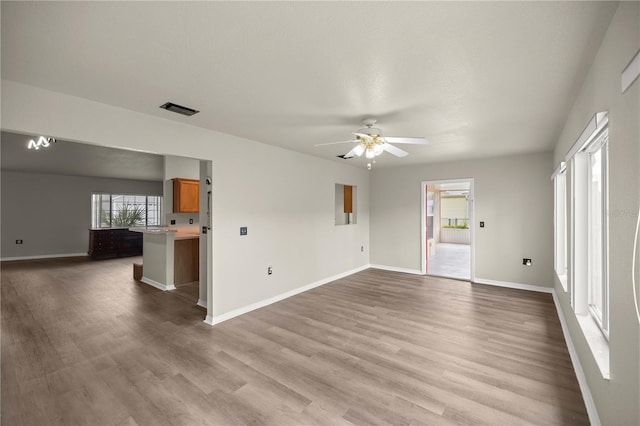 unfurnished living room with hardwood / wood-style floors and ceiling fan