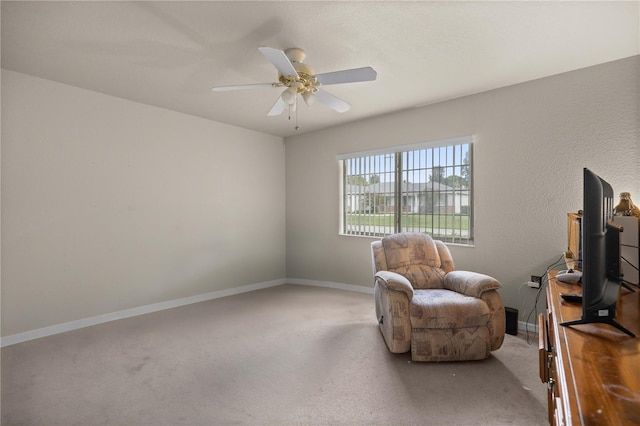 living area with ceiling fan and carpet floors